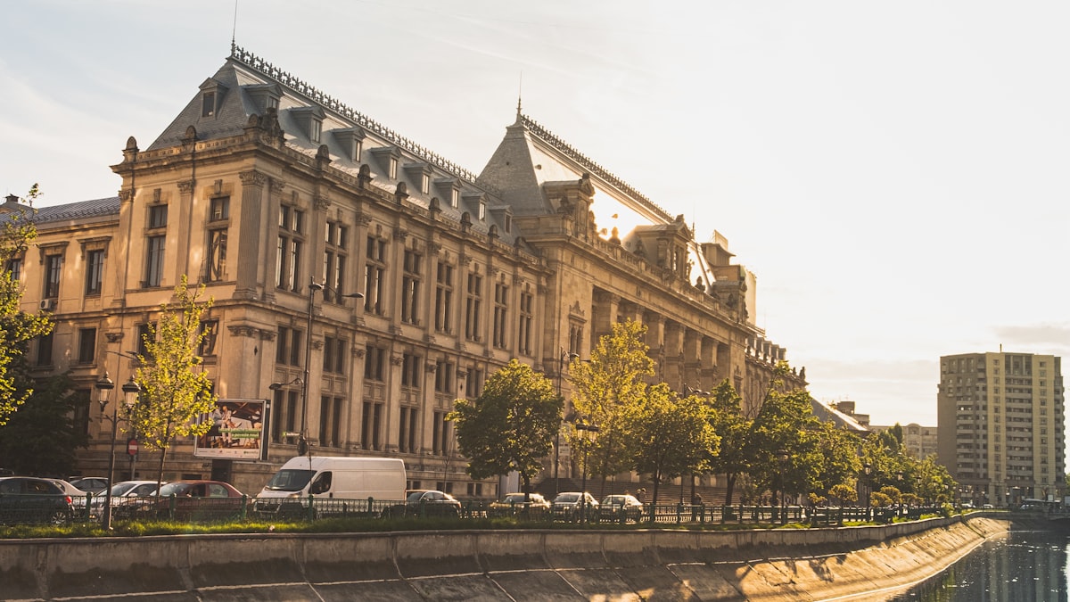 Bucharest's grand institutional buildings frame a fiscal battle over Romania's credit rating and borrowing costs.